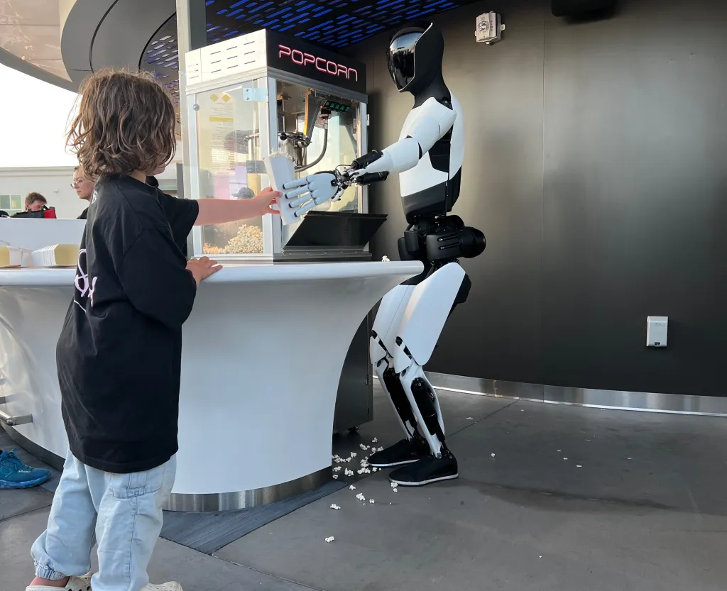 tesla bot optimus hands boy 1011546163